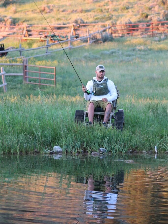 Veteran fishing from a track chair.