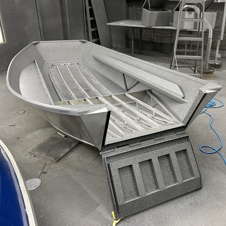 Mid-production Koeffler Accessible Drift Boat displaying the front of the boat, open like a landing craft. This boat allows accessibility by mobility-challenged persons.